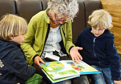 Older adult reading with kids