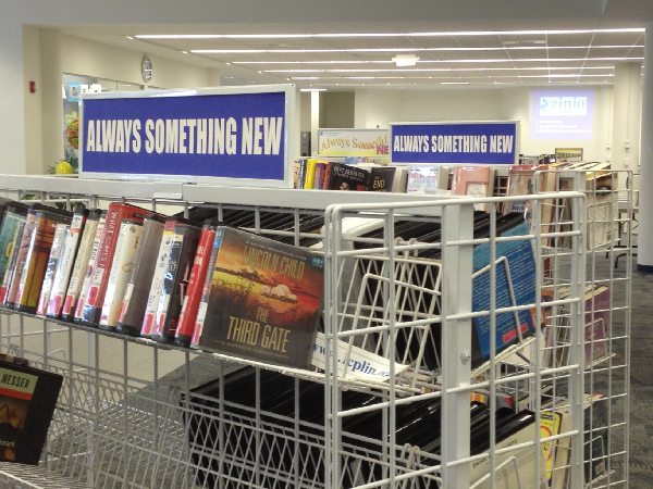 Rack of new books, audiobooks, and movies