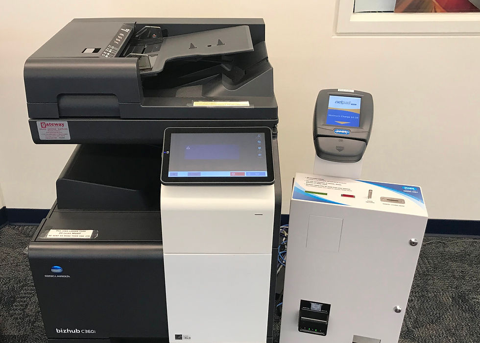 the copy machine with a coin box and card reader next to it