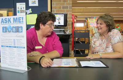librarian helping someone with a job application
