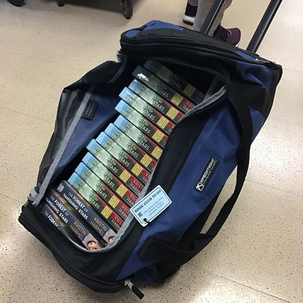 A rolling suitcase unzipped to show it's full of books