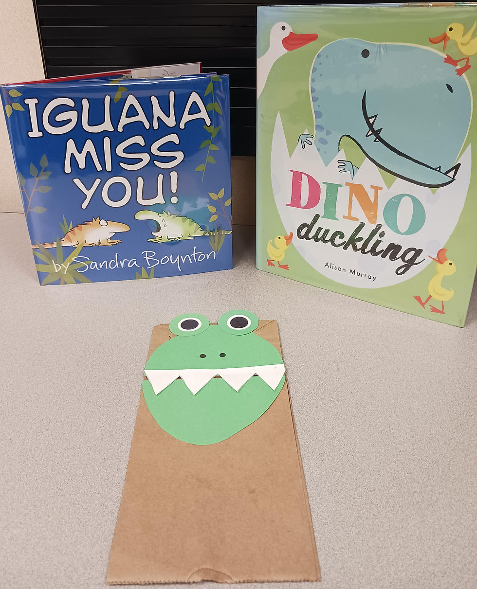 The two books pictured with a paper bag dinosaur puppet craft described below