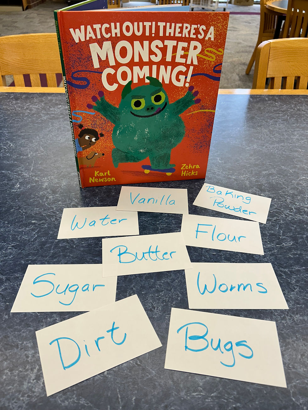 The book shows a green monster skateboarding across the cover, while a child watches with wide eyes. There are index cards with words like vanilla, bugs, dirt, and sugar on the table in front of the book