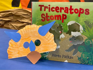 The picture book shows baby triceratops emerging from eggs. It is pictured with the craft described below