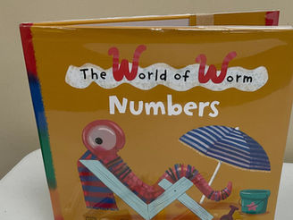 The book cover shows a happy worm reclining on a beach chair