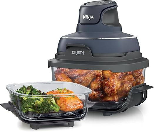 air fryer with a clear body containing chicken and vegetables