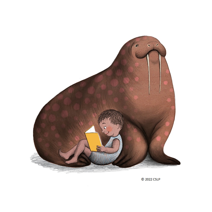 A child leaning against a walrus and reading