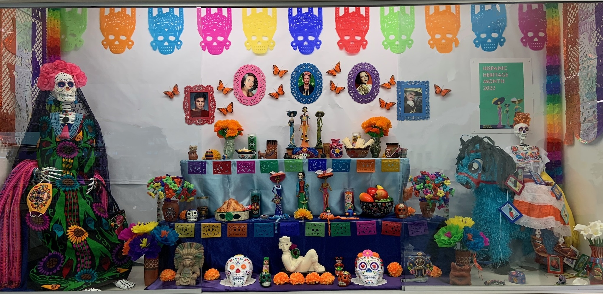A large display case holding colorful dia de los muertos decorations