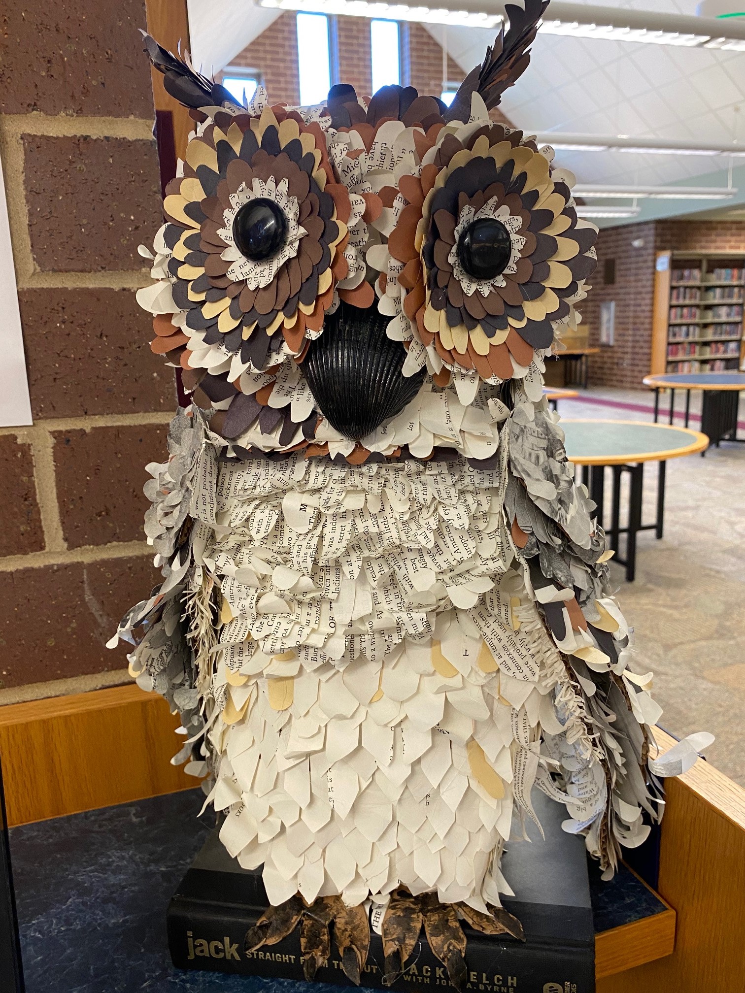 A 3D owl made of the pages of a discarded book