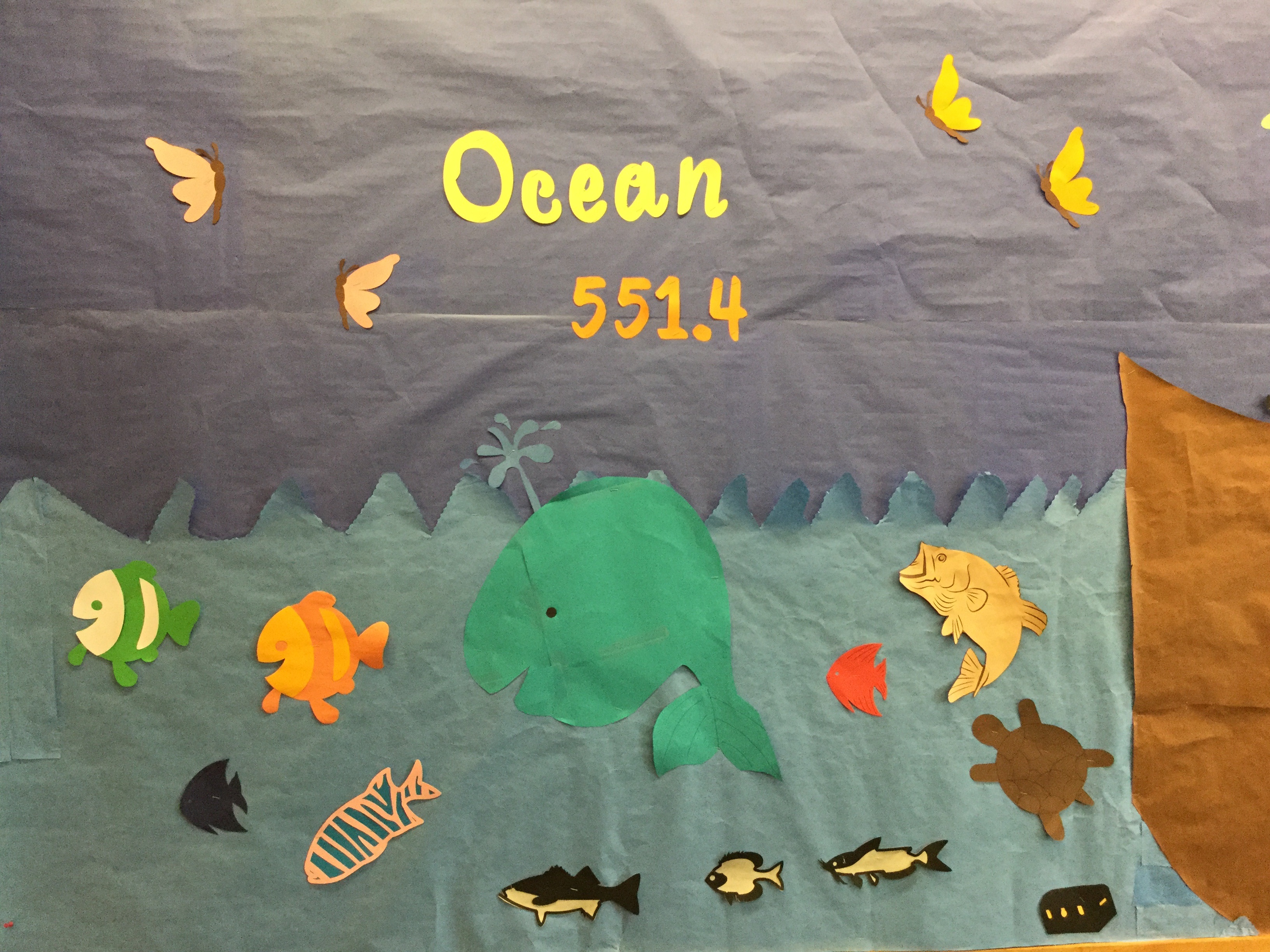 Photo of a bulletin board decorated with paper ocean cut outs